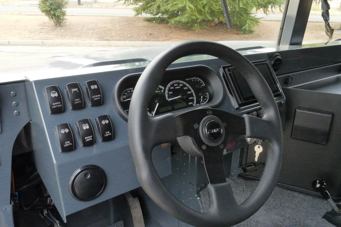 Close-up of powder-coated aluminum dash for humvee with rocker switches and gauges