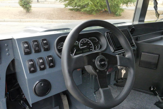 Close-up of powder-coated aluminum dash for humvee with rocker switches and gauges